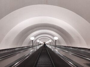 grayscale photography of an escalator