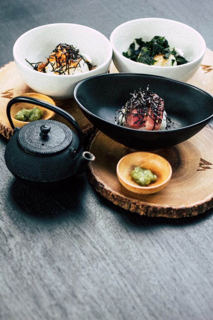 nigiri on black bowl with wasabe