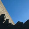 low-angle photography of gray concrete building under calm blue sky
