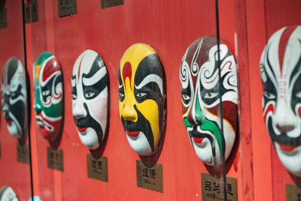 a row of masks on a red wall