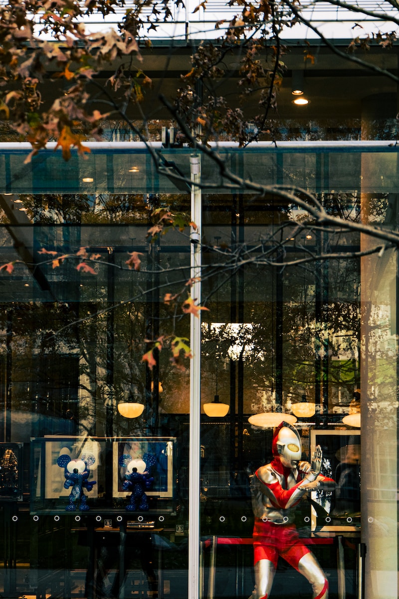 a statue of a man in a red suit is in the window of a store