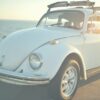 white Volkswagen Beetle on road at daytime
