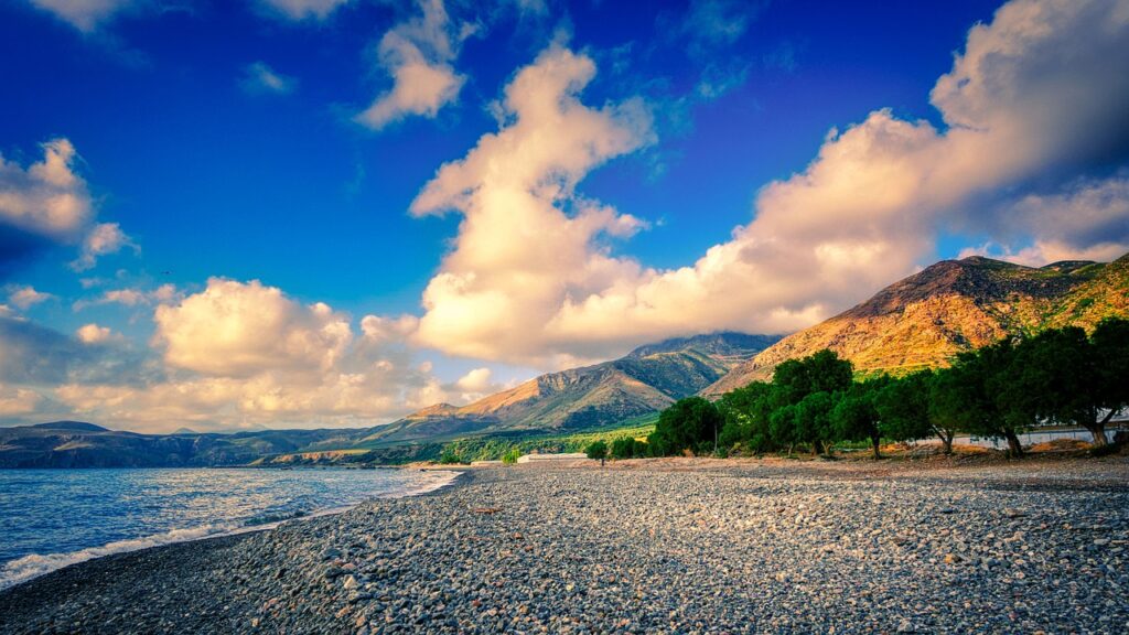 Beach Pebbles Coast Mountains Sea  - fietzfotos / Pixabay