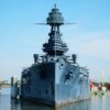 gray battleship on body of water during daytime