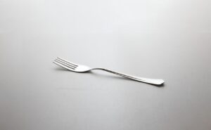 silver fork on white surface