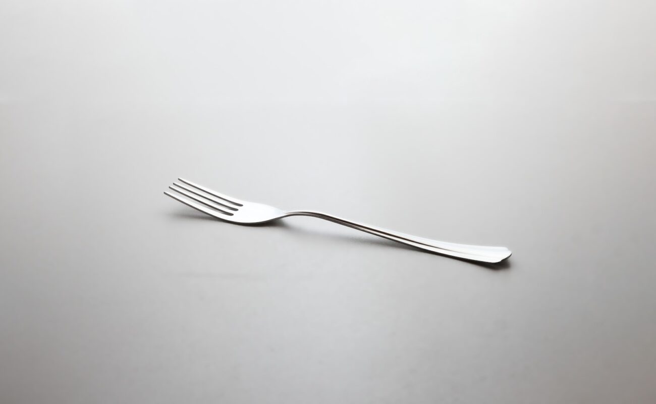 silver fork on white surface