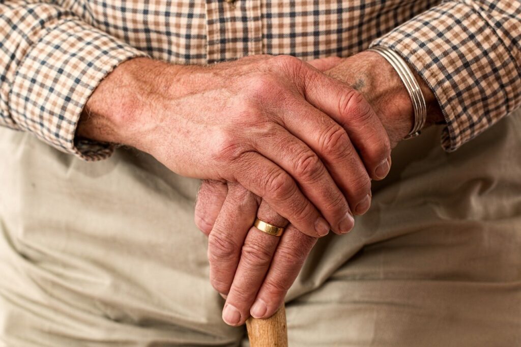 elderly hands ring walking stick 981400