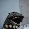 a large godzilla head on top of a building