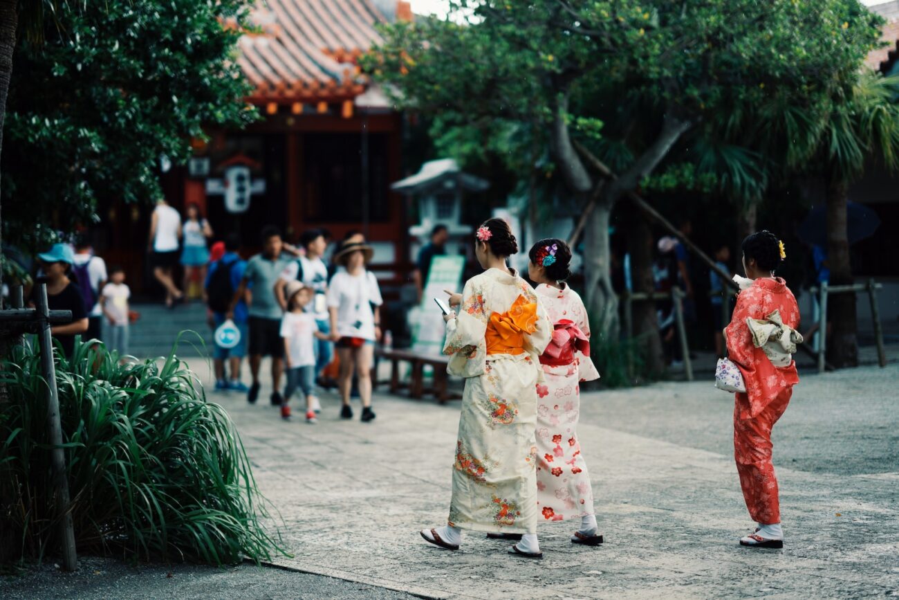 woman in white and red floral kimono walking on street during daytime