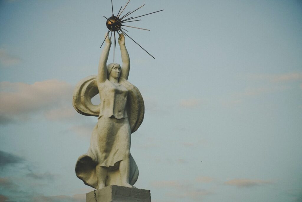 a statue of a woman holding a star above her head