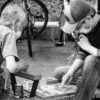 a person and a boy playing chess