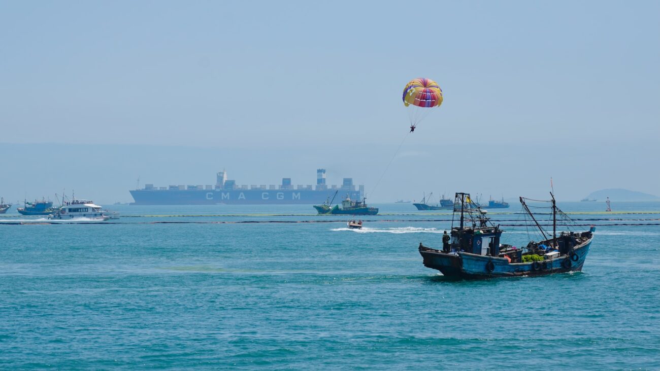 black boat on sea during daytime