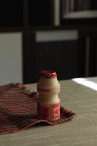 Yakult plastic bottle on table