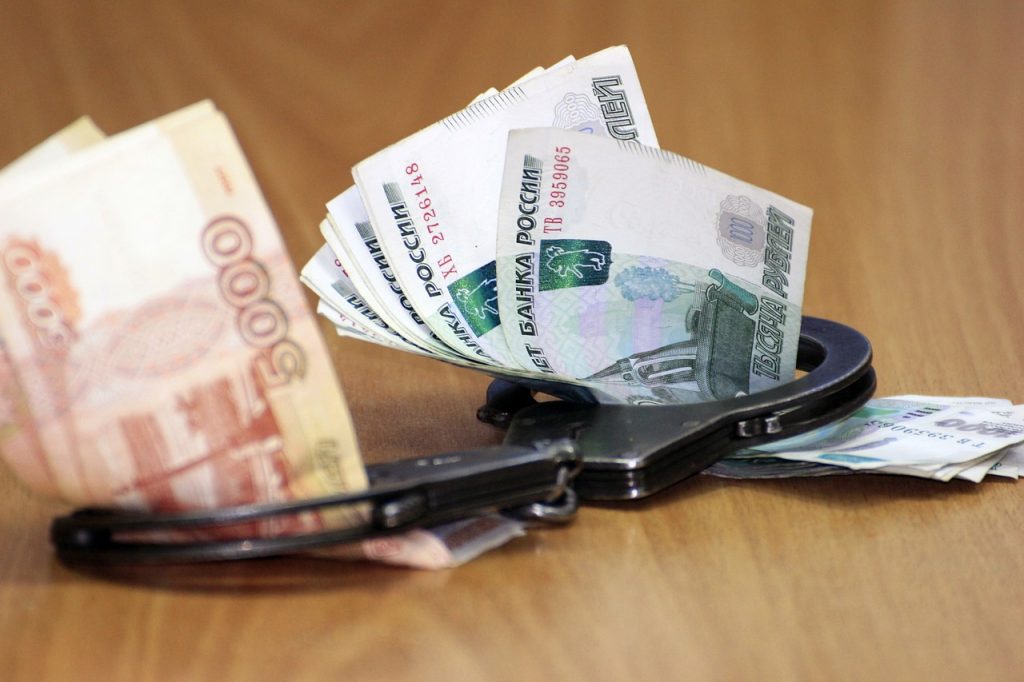 Handcuffs Money Corruption Economy  - sajinka2 / Pixabay