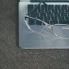 clear eyeglasses with black frames on laptop