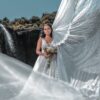 woman in white wedding gown standing on snow covered ground during daytime