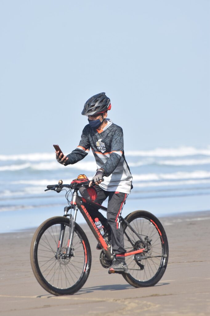 Man Bike Phone Beach Sand Ride  - djembararafat98 / Pixabay