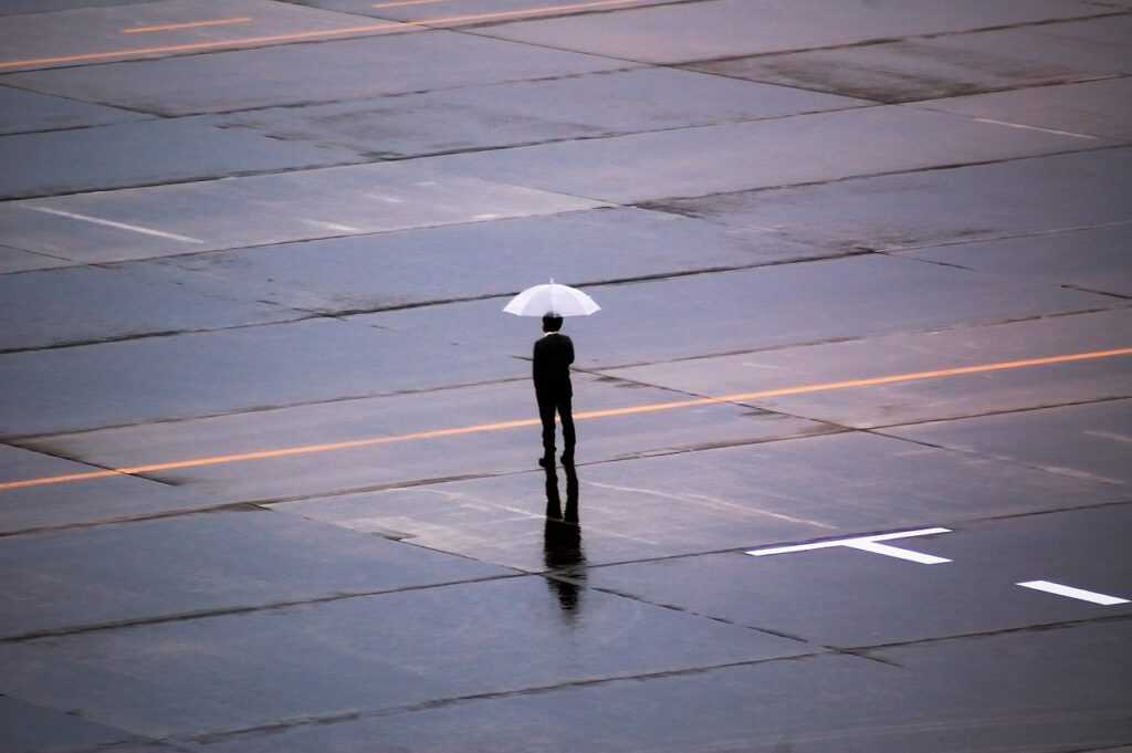 Man Rain Umbrella Street Plaza  - tasukaran / Pixabay