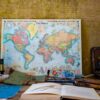 world map poster near book and easel