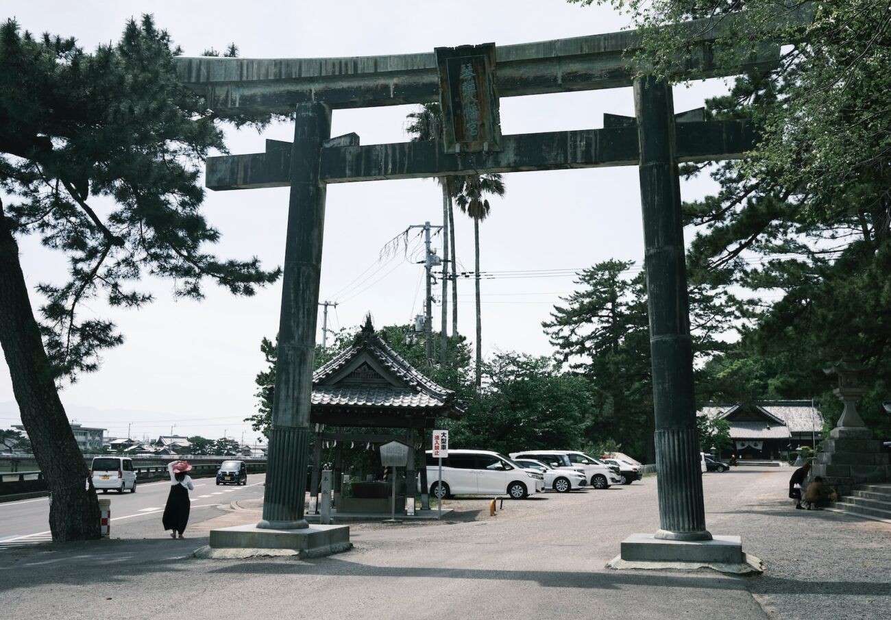 people walking on street near black metal gate during daytime