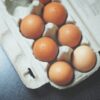 seven brown eggs on tray