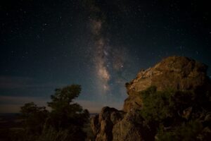 rock formation mountain under sky with stars