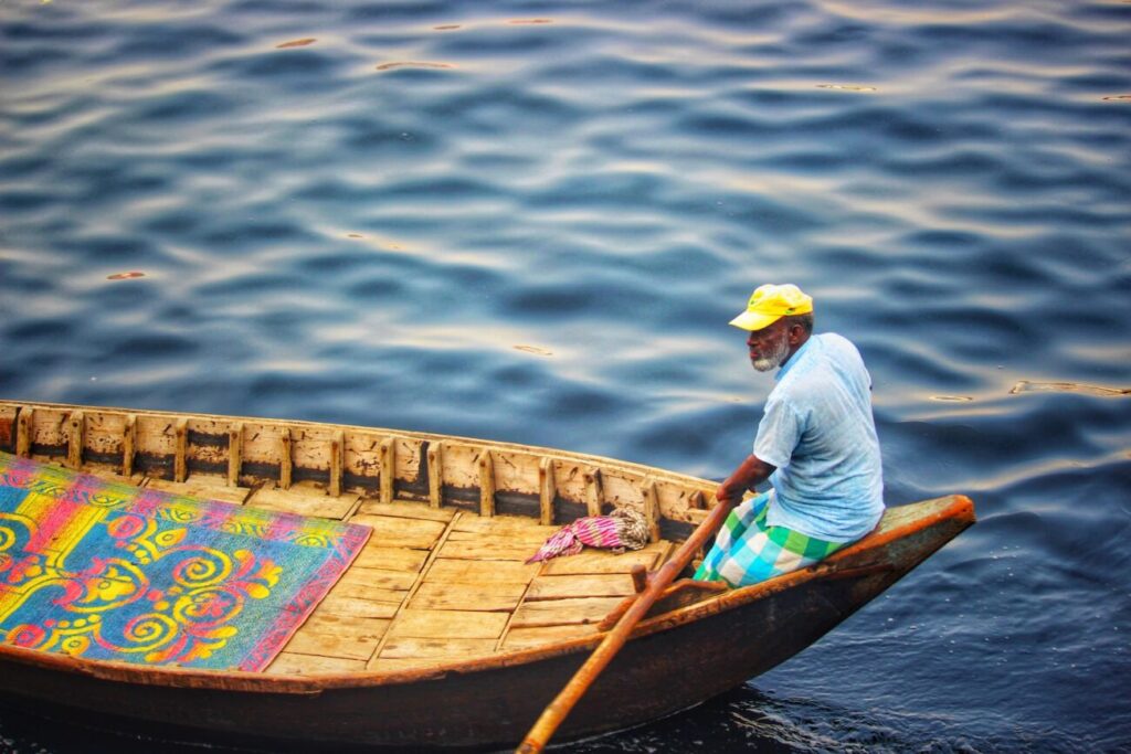 man riding boat during daytime
