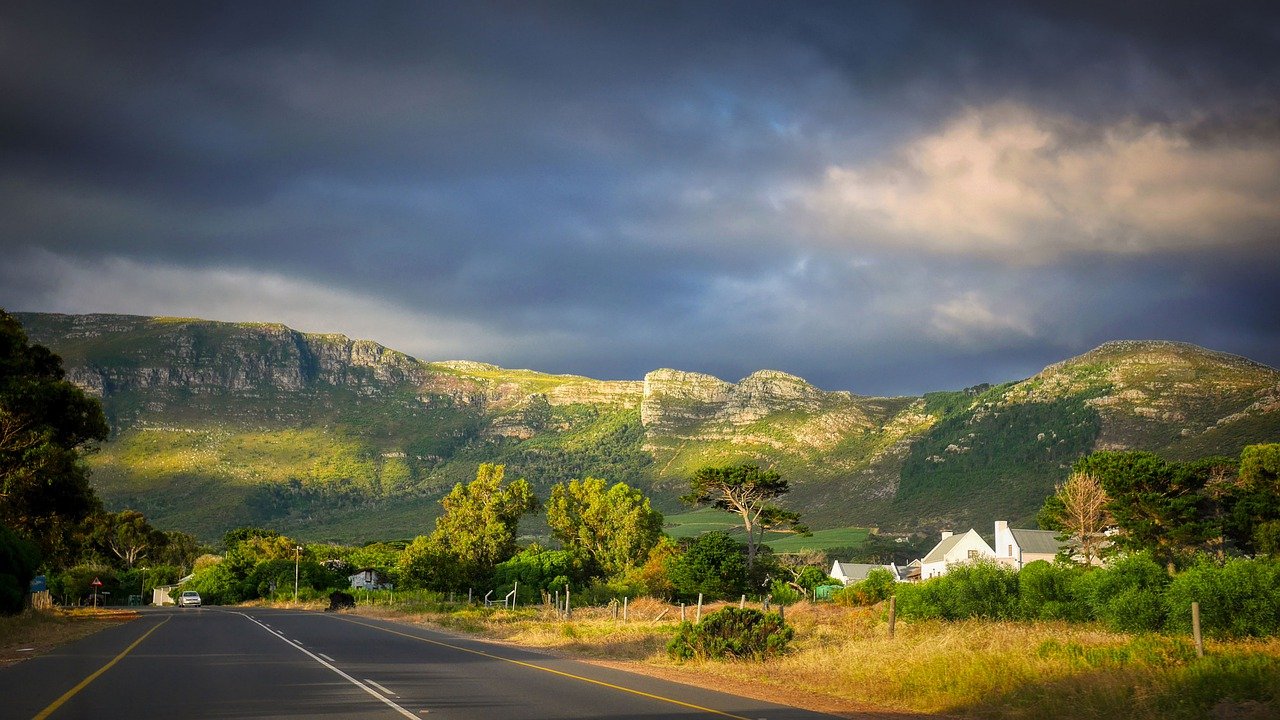Road Mountain Clouds Houses Street  - fietzfotos / Pixabay