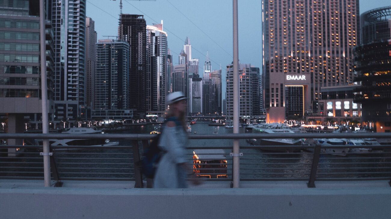 woman wearing dress walking near railway
