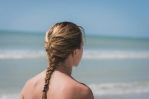 back view photo of woman with braided hair near sea