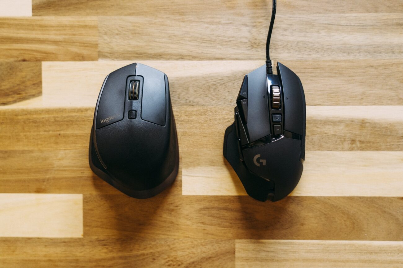 black corded computer mouse on brown wooden table