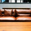 brown leather two-seat sofa