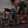 a close up of a dragon figurine on a board game
