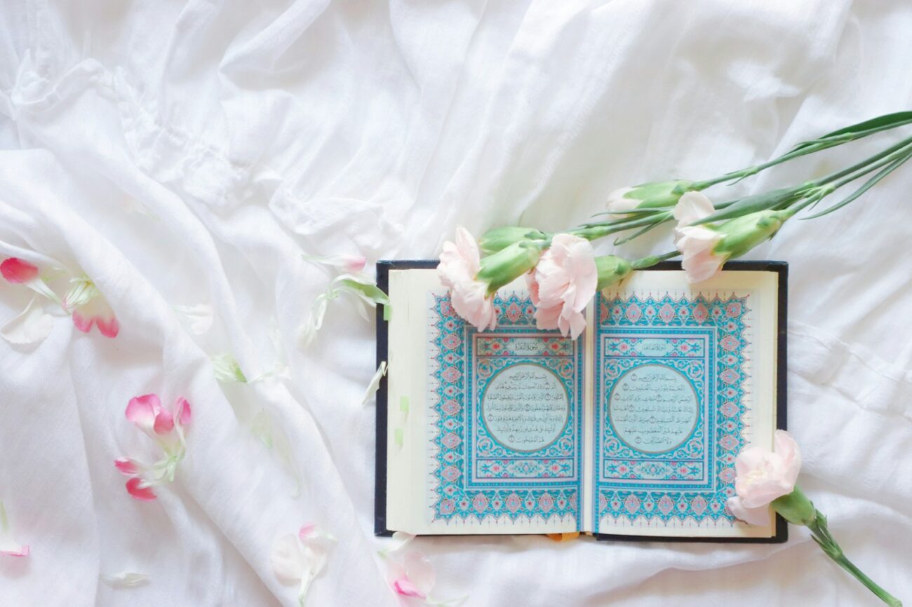 blue and white book on white and pink floral textile
