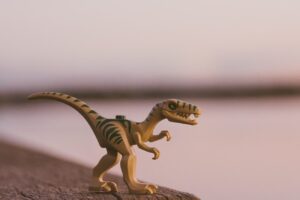 green and brown dinosaur toy
