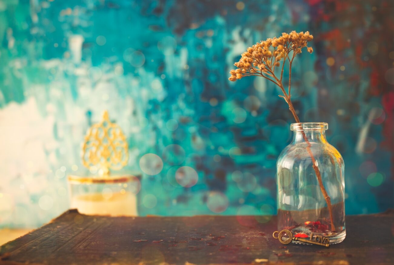 white flowers in clear glass jar