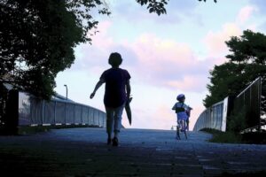 a woman and a child walking down a sidewalk