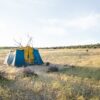 blue and yellow cabin tent on field